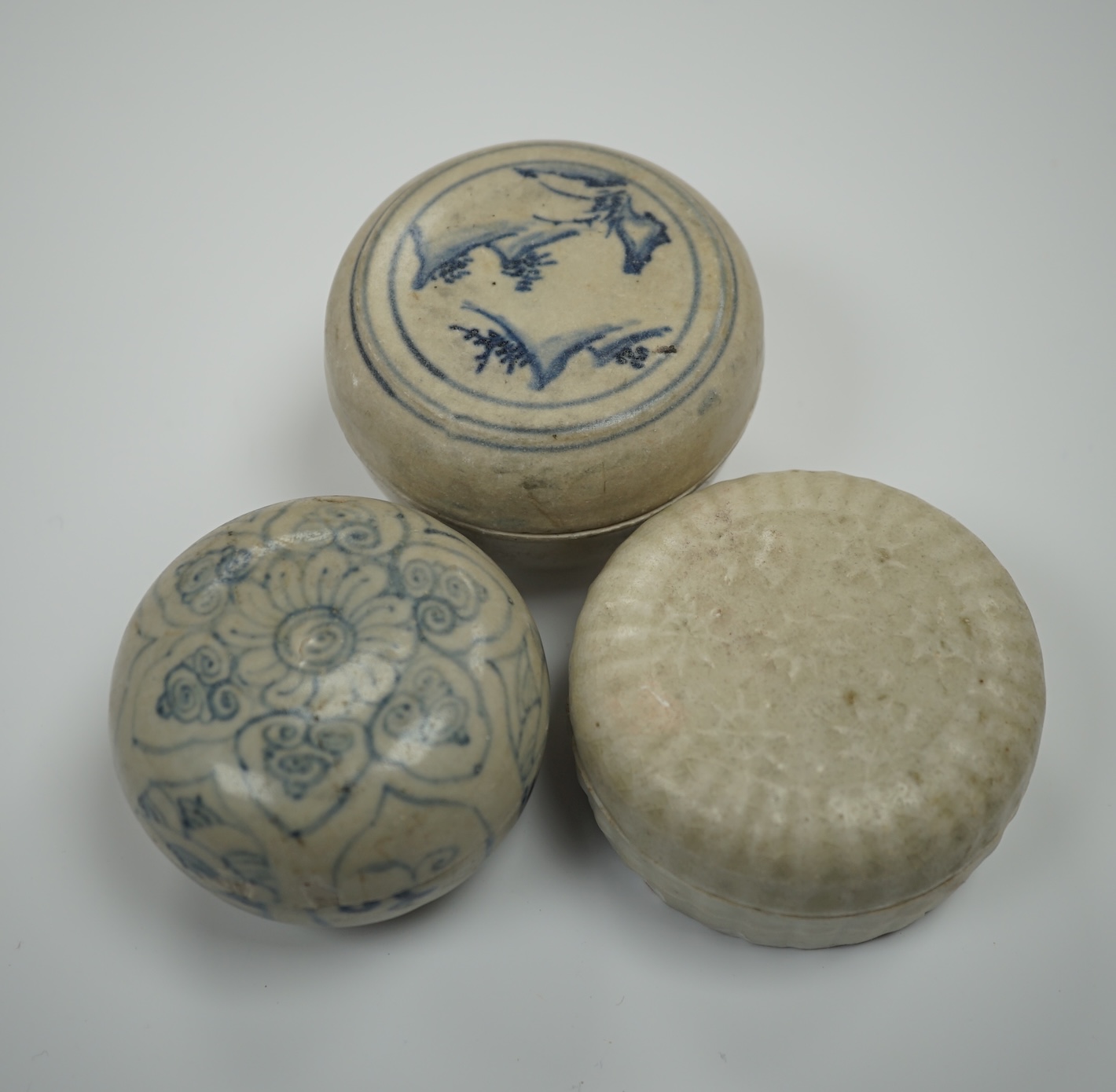 Two Annamese Chinese blue and white boxes and covers, 15th/16th century and a Dehua moulded box and cover, Ming dynasty